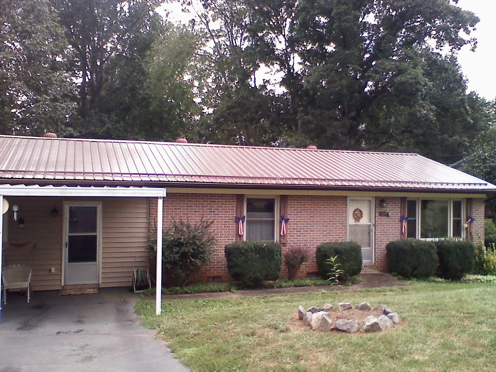 Bronze metal roof and carport on a brick ranch home — Roof Repair work by our crew in Toluca